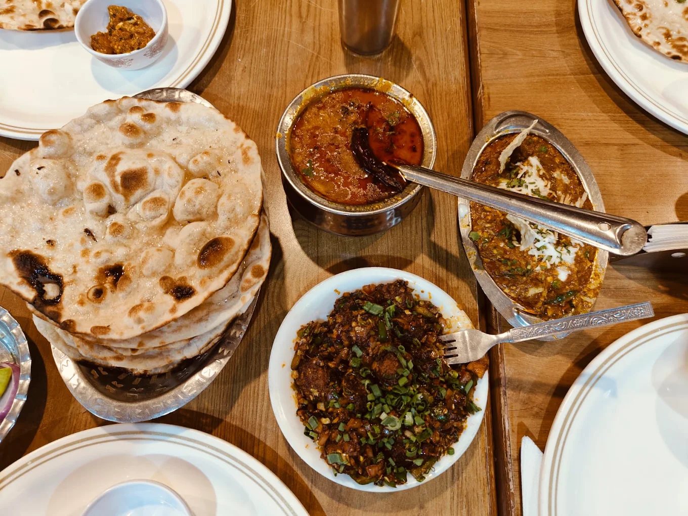 A table laid with rotli, shaak and dal